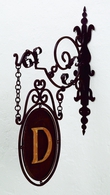 Bracket with Hanging Oval Shield Monogrammed on One Side